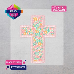 May include: A floral cross DTF transfer with a pink gingham border. The cross is filled with a colorful floral pattern of pink, orange, and green flowers. The image includes the text "SILKY DTF", "READY TO PRESS", and "DTF TRANSFER".