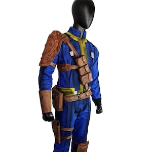May include: A blue jumpsuit with yellow accents, brown leather shoulder armor, and pouches. The costume includes a belt, leg straps, and a holster. The outfit is displayed on a mannequin, showcasing a detailed cosplay design.