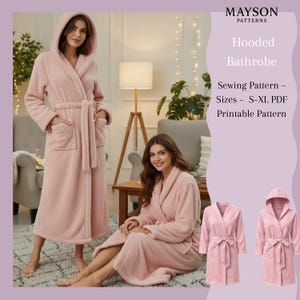 May include: A soft, pink hooded bathrobe with a matching belt and pockets. The image shows two people wearing the robe, and two additional images of the robe. Text on the image reads "Hooded Bathrobe" and "Sewing Pattern - Sizes S-XL PDF Printable Pattern."