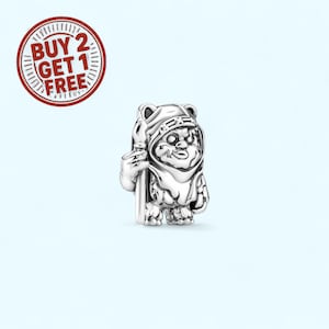 May include: A silver-colored charm depicting a character from a popular science fiction franchise. The charm is a small, detailed figure of an Ewok holding a staff. The charm is set against a light blue background.