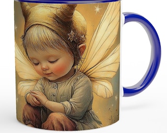 May include: A white ceramic mug with a blue interior and handle. The mug features a whimsical illustration of a fairy child with wings, wearing a horned headdress. The artwork has a soft, dreamlike quality.