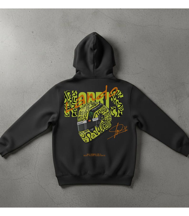 May include: Black hooded sweatshirt with a graphic design on the back. The design features the name "NORRIS" in a neon green and orange color scheme, along with a stylized racing helmet and signature. The text "BEAT YOUR TEAM MATE" is also visible.