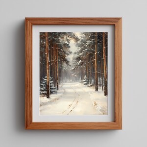 Peut inclure: Peinture encadrée d'un paysage hivernal. L'œuvre représente un chemin enneigé serpentant à travers une forêt de grands arbres couverts de neige. Le cadre est en bois brun clair, évoquant la tranquillité.