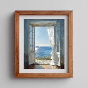 May include: A framed painting depicts an open doorway with white doors and a sheer white curtain. The view through the doorway reveals a bright blue ocean under a clear sky. The frame is made of light brown wood.
