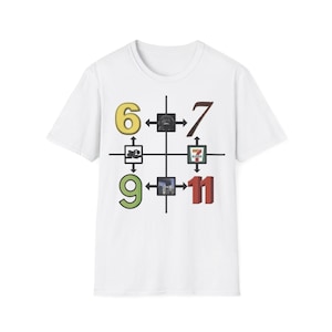 May include: White t-shirt with a graphic design featuring the numbers 6, 7, 9, and 11 in various colours. The numbers are arranged around a central crosshair design with small images. The shirt is made of a soft, comfortable material.