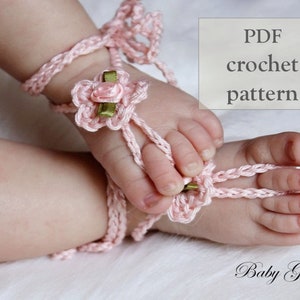 May include: A pink crocheted baby sandal with a pink and green flower embellishment. PDF crochet pattern. Baby Grace.