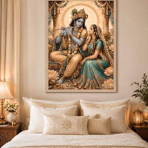 May include: A framed wall art print depicting a blue-skinned deity playing a golden flute while seated beside a woman in a teal and gold sari. They are surrounded by lotus flowers and ornate architectural pillars in a warm, golden-toned setting.