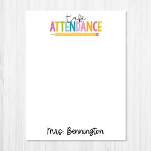 May include: White notepad with the text "take attendance" in colorful letters with a yellow pencil underneath. The text "Mrs. Bennington" is at the bottom of the notepad.