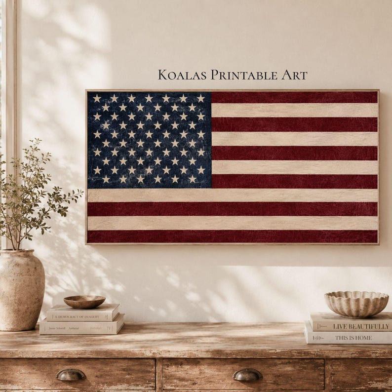 May include: A rectangular wall art print featuring the United States flag with a distressed, textured appearance in muted red, white, and dark blue. The text KOALAS PRINTABLE ART is centered above the flag. The design has a weathered finish.