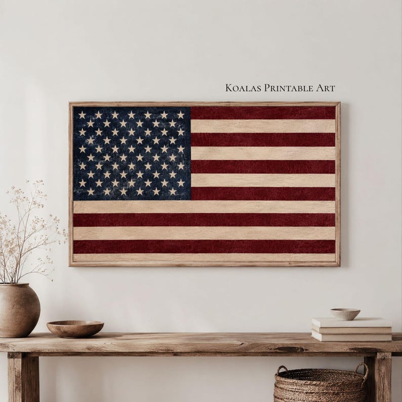May include: A rectangular wall art print featuring the United States flag with a distressed, weathered texture. The design displays a dark blue canton with white stars and alternating horizontal red and off-white stripes. Text reads Koalas Printable Art.