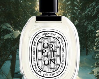 May include: A clear glass perfume bottle with a black cylindrical cap. The oval label features the text ORPHÉON, diptyque, 34 boulevard saint germain, and paris 5e. The label has a black and white geometric pattern background with black lettering.