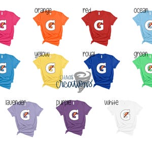 May include: A set of 12 t-shirts in various colors with a white G logo on each. The colors include pink, aqua, orange, red, ocean, yellow, royal, green, lavender, purple, and white.