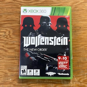 May include: A physical Xbox 360 video game case for Wolfenstein: The New Order. The cover art features three silhouetted figures in helmets with glowing red eyes against a red background, with the title text and a Bethesda logo at the bottom.