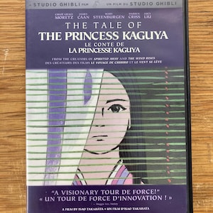 May include: DVD of "The Tale of the Princess Kaguya" by Studio Ghibli. The cover has a purple background with the film's title in white and a stylized illustration of a woman's face. Includes text in English and French.