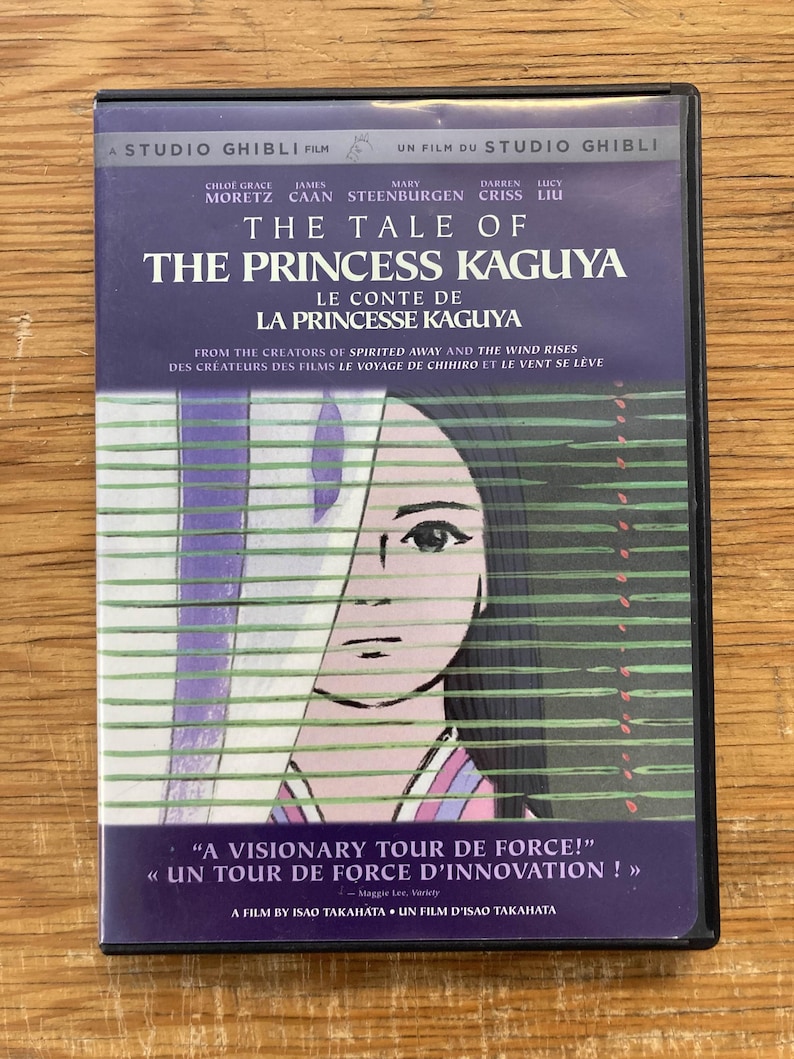 May include: DVD of "The Tale of the Princess Kaguya" by Studio Ghibli. The cover features a purple background with the film's title in white and a stylized illustration of a woman's face. Includes text in English and French.