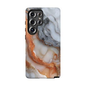 May include: A smartphone case with a marbled design in shades of white, gray, and orange. The case has a glossy finish and features a camera module with multiple lenses. The design resembles natural stone with gold accents.
