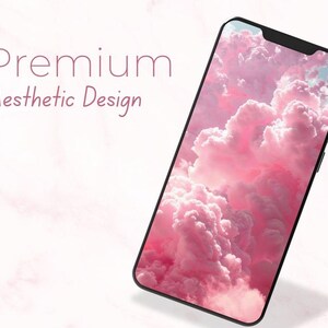 May include: A smartphone displays a pink cloudscape wallpaper. The phone is black with a sleek design. The words "Premium Aesthetic Design" are written in a soft, elegant font above the phone.
