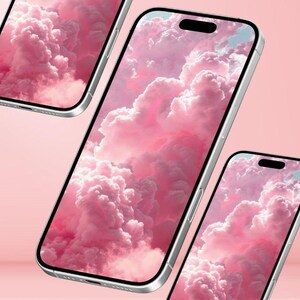 May include: Three silver smartphones with screens displaying a pink cloudscape. The phones are angled, showcasing the screen's wallpaper against a soft pink background. The screens have a black notch at the top.
