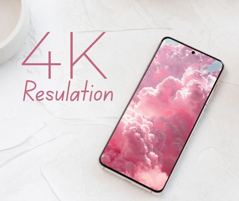 May include: A smartphone with a pink cloud wallpaper, angled on a white surface. The phone's screen displays a vibrant image of fluffy pink clouds. The text "4K Resolution" is written in pink above the phone.