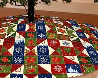 May include: A circular Christmas tree skirt featuring a patchwork design of squares and triangles in red, green, blue, and white. The fabric displays patterns of snowflakes, poinsettias, gingerbread men, candy canes, and pine trees.