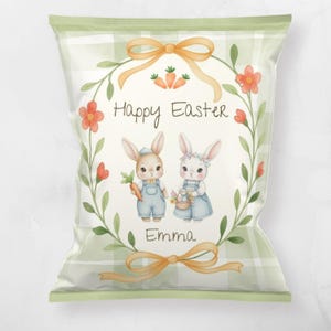 May include: A green and white plaid Easter-themed bag with a watercolor illustration. The illustration features two bunnies, a floral wreath, carrots, and the words "Happy Easter" and "Emma". The bag has a bow at the top and bottom.