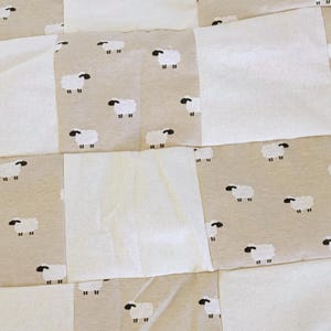 With love from grandma and Harlow. Little sheeps to count while baby sleeps. Hand crafted patchwork quilt blended with off white squares.