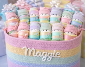 20 diaper babies in a personalized multi pastel basket with other baby essentials. Makes a great baby shower gift.
