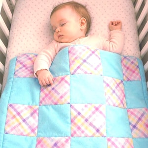 Pastel baby color patchwork quilt with baby green squares and solid baby green backing. 100% soft cotton flannel. Fits boy or girl nursery