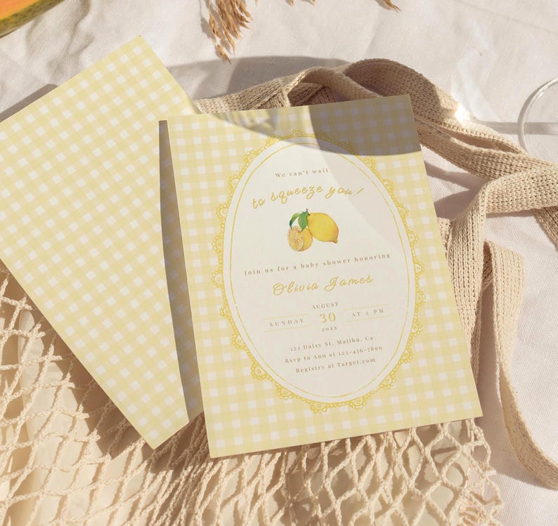 May include: Baby shower invitations with a yellow gingham pattern. The invitation features text in a decorative oval frame with lemon illustrations. The text reads "We can't wait to squeeze you!" and includes the name Olivia James.