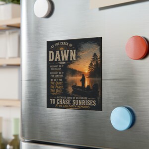 May include: A rectangular magnet with a fishing theme. The magnet features a scenic image of a lake at sunrise with a person fishing from a boat. Text on the magnet reads "At the Crack of Dawn" and other related phrases.