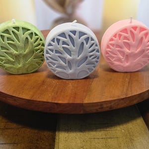 May include: A white ceramic mug with a black handle and the text "But First, Coffee" in a handwritten style. The mug is on a white surface. The mug is approximately 4 inches tall.