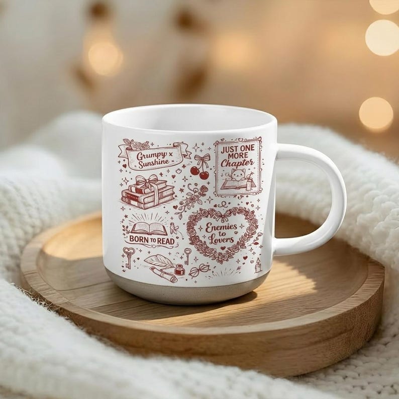 May include: White ceramic mug with a gray base, featuring red illustrations of books, hearts, and text. The mug includes the phrases "Grumpy x Sunshine", "Born to Read", and "Just One More Chapter".