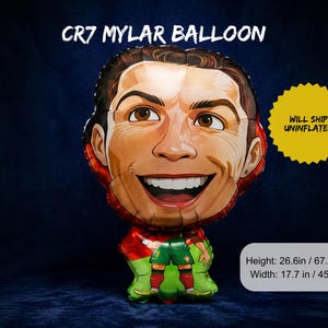May include: A mylar balloon featuring a smiling cartoon image of a soccer player. The balloon is red, green, and brown, with the text "CR7 MYLAR BALLOON" at the top. The balloon is 26.6 inches tall and 17.7 inches wide.