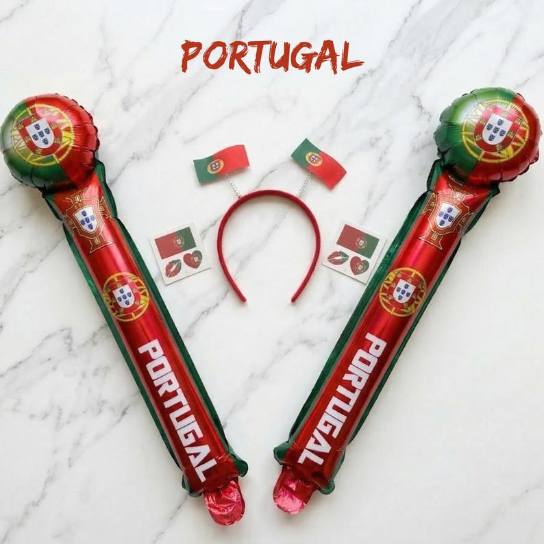 May include: Two inflatable red and green cheering sticks featuring the Portugal flag and the word PORTUGAL, a red headband with two small Portugal flag antennae, and two square stickers displaying the Portugal flag and a red heart shape.