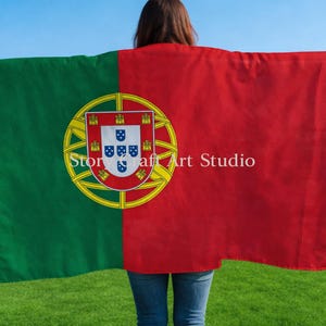 May include: A large rectangular flag of Portugal, with a green field on the left and a red field on the right. The Portuguese coat of arms is centered on the green and red division. The text "Stor craft Art Studio" is printed on the flag.
