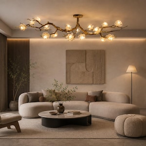 May include: A branch-shaped chandelier with a dark textured finish and multiple glowing, flower-like glass light fixtures. The fixture extends horizontally across the ceiling, featuring numerous illuminated bulbs encased in translucent, petal-shaped glass shades.