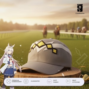 May include: A gray baseball cap with a white and yellow geometric design. The cap is displayed on a wooden surface with a blurred background of a horse race. The text "Premium Embroidery", "Guarantee", "Soft Fabric", and "Neat Stitching" are visible.