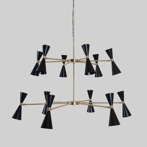 May include: A mid-century modern chandelier with a two-tiered design. It features black cone-shaped shades and brass-colored arms extending from a central hub. The light fixture hangs from a chain.