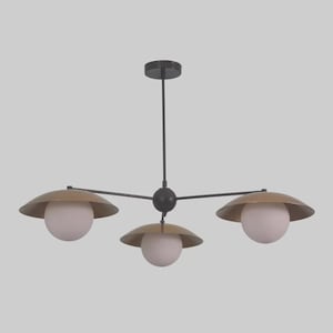 May include: A modern three-light chandelier with a black frame and gold-toned shades. Each shade has a white globe light. The fixture is suspended from a black ceiling mount.