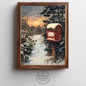 May include: A framed winter landscape painting featuring a snow-covered path leading to a red mailbox. The scene includes evergreen trees, holly bushes with red berries, and a sunset in the background. The artwork is in a wooden frame.