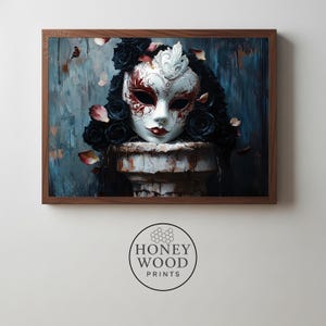 May include: A framed print of a Venetian mask in white and red, decorated with black roses and a headpiece. The mask sits on a weathered, white column against a textured blue and brown backdrop. The artwork is framed in dark wood.
