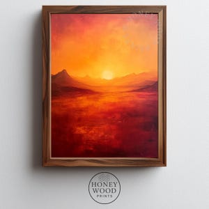 May include: A framed landscape painting depicting a sunset over a body of water and mountains. The artwork features a warm color palette of orange, red, and brown hues. The frame is made of dark wood, and the bottom of the frame has the text "HONEY WOOD PRINTS".