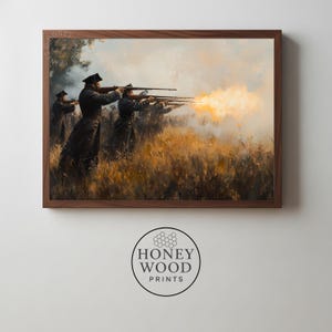 May include: Framed print depicting a historical battle scene. Soldiers in dark coats and hats fire muskets, with bright orange muzzle flashes. The artwork is set in a field of tall, golden grass, under a cloudy sky. The frame is a dark wood. The Honey Wood Prints logo is at the bottom.