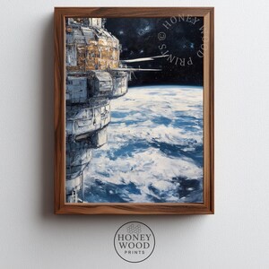May include: A framed art print featuring a detailed space station orbiting a blue and white planet. The station has metallic grey and gold panels. The background shows a dark starry expanse. The text HONEY WOOD PRINTS is visible in the corner.