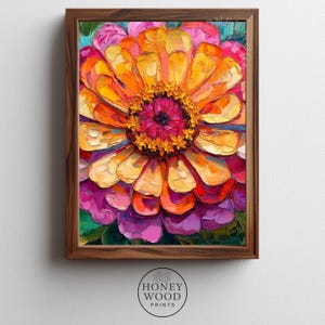 May include: A framed floral art print featuring a vibrant, impressionistic painting of a zinnia flower. The artwork showcases a spectrum of colors, including yellow, orange, pink, and purple, with a dark brown wooden frame. The print is from Honey Wood Prints.