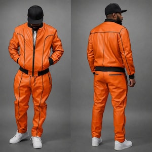 May include: Orange leather tracksuit with black trim. The jacket has a zip-up front and the pants have pockets. The outfit is paired with a black baseball cap and white sneakers. The tracksuit is shown from the front and back.