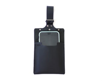 May include: Black leather phone case with a strap and a pocket on the back. The case has the initials "NH" embossed on the front.