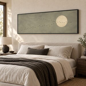 May include: A long, rectangular wall art piece in a black frame featuring a muted sage green background, a large pale yellow circular moon, and a flock of small black birds flying in a diagonal formation across the center of the canvas.