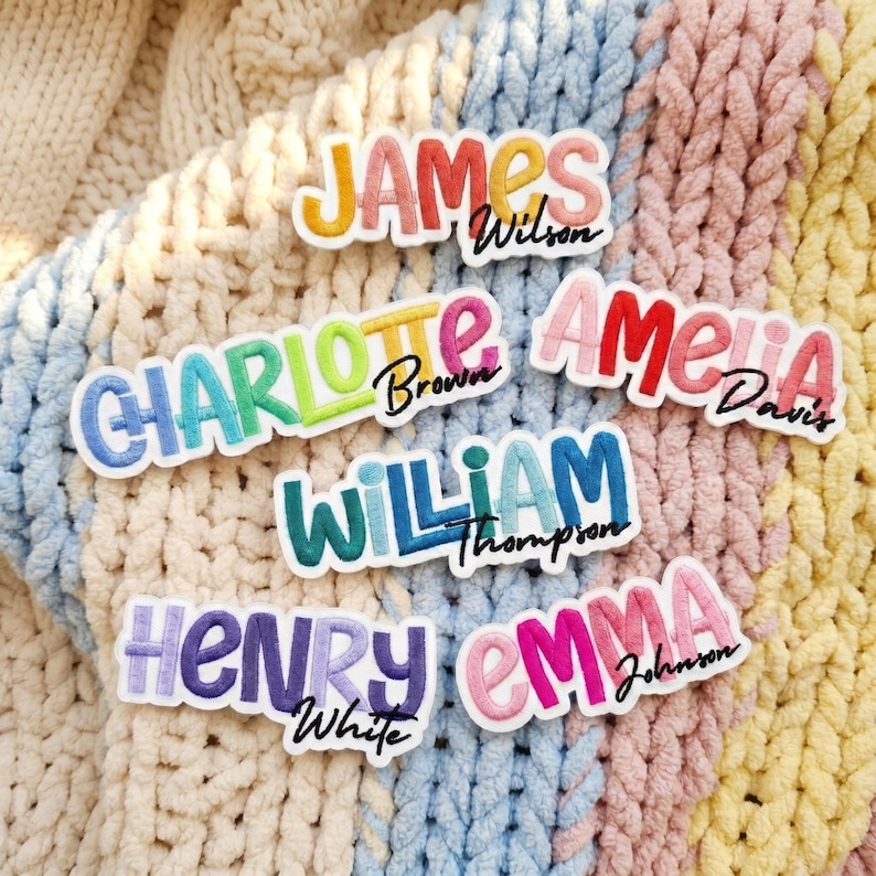 May include: A collection of six embroidered name patches featuring colourful, bubble-style lettering. The names include James Wilson, Charlotte Brown, Amelia Davis, William Thompson, Henry White, and Emma Johnson, each with a black cursive surname.