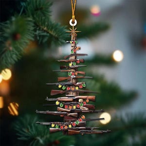 K&ouml;nnte beinhalten: Ein Weihnachtsbaumschmuck in Form eines Baumes, der aus Gewehren besteht. Die braunen Gewehre sind in Form eines Baumes angeordnet, mit bunten Lichterketten dazwischen. Der Schmuck h&auml;ngt an einem goldenen Faden.